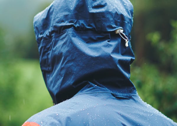 person-in-wet-raincoat-hood